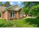 Brick home exterior featuring manicured lawn, trimmed bushes, and bright windows, providing great curb appeal at 2016 Townview Dr, Kannapolis, NC 28081