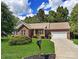 Charming brick home with a well-manicured lawn, mature trees, and an inviting front porch at 2016 Townview Dr, Kannapolis, NC 28081