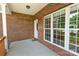 Covered front porch featuring brick facade, large windows, and a welcoming front door, perfect for relaxing at 2016 Townview Dr, Kannapolis, NC 28081