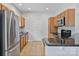 Well-lit kitchen featuring stainless steel appliances, granite countertops, and ample cabinet space for storage at 2016 Townview Dr, Kannapolis, NC 28081