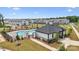Community pool area featuring a modern pool house, lounge chairs, and manicured landscaping in a new neighborhood at 3119 Beacon Heights Rd, Indian Land, SC 29707