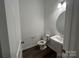 Modern powder room featuring a pedestal sink, oval mirror, and clean, bright finishes at 3125 Beacon Heights Rd, Indian Land, SC 29707