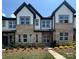 Attractive townhome with brick facade, gray siding, black accents, and professionally landscaped front yard at 3125 Beacon Heights Rd, Indian Land, SC 29707