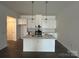Bright kitchen featuring a large island, white cabinetry, stainless steel appliances, and pendant lighting at 3125 Beacon Heights Rd, Indian Land, SC 29707
