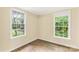 Bright bedroom with two windows and attractive wood-look floors at 315 Rivers St, Rock Hill, SC 29730