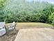 This backyard offers a serene view of a lush tree line, providing privacy and a natural ambiance at 3678 Privette Rd # 349, Matthews, NC 28104