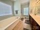 Bright bathroom featuring a soaking tub and a walk-in shower at 3678 Privette Rd # 349, Matthews, NC 28104