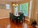 The dining room features a dark wood table, seating for six, and is bathed in natural light from multiple windows at 3678 Privette Rd # 349, Matthews, NC 28104
