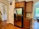 Kitchen featuring stainless steel refrigerator, dark wood cabinets, and granite countertops at 3678 Privette Rd # 349, Matthews, NC 28104