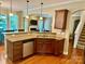 Kitchen featuring granite countertops, a stainless steel dishwasher, and dark wood cabinets at 3678 Privette Rd # 349, Matthews, NC 28104