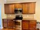 Kitchen with stainless steel appliances, dark wood cabinets, and granite countertops at 3678 Privette Rd # 349, Matthews, NC 28104