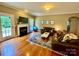 The living room boasts hardwood floors, a fireplace, and a large sectional couch at 3678 Privette Rd # 349, Matthews, NC 28104