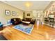 The living room showcases hardwood floors, a brown leather couch, and a decorative rug at 3678 Privette Rd # 349, Matthews, NC 28104