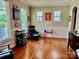 Bright living room with hardwood floors, wainscoting, and large windows at 3678 Privette Rd # 349, Matthews, NC 28104
