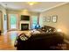 The living room features hardwood floors, a fireplace, and a large sectional couch at 3678 Privette Rd # 349, Matthews, NC 28104