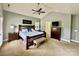 A generously sized main bedroom with wood furniture, carpet, and a ceiling fan at 3678 Privette Rd # 349, Matthews, NC 28104