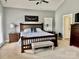The main bedroom includes a wood bed frame, neutral walls, and a seating bench for a serene and relaxing space at 3678 Privette Rd # 349, Matthews, NC 28104