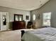 The main bedroom is spacious and features carpet, neutral paint, wood furniture, and a window at 3678 Privette Rd # 349, Matthews, NC 28104