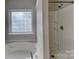 Bathroom featuring a shower and soaking tub with natural light from a glass block window at 3711 Green Pasture Rd, Charlotte, NC 28269