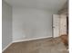 This bedroom features neutral walls, carpet flooring and a large doorway at 3711 Green Pasture Rd, Charlotte, NC 28269