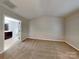 A carpeted bedroom with a view into the en-suite bathroom with a vanity at 3711 Green Pasture Rd, Charlotte, NC 28269