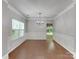 Formal dining room featuring wainscoting, hardwood floors, and an elegant chandelier at 3711 Green Pasture Rd, Charlotte, NC 28269