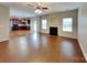 Open concept living room featuring hardwood floors, fireplace, and backyard access at 3711 Green Pasture Rd, Charlotte, NC 28269