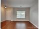 A view of a living room with hardwood floors and a large window providing natural light at 3711 Green Pasture Rd, Charlotte, NC 28269