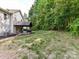 Spacious backyard with a covered patio area perfect for outdoor entertaining, surrounded by lush greenery at 3801 Creek Ridge Dr, Denver, NC 28037