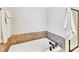 A relaxing soaking tub with stylish tile surround and modern fixtures at 3801 Creek Ridge Dr, Denver, NC 28037