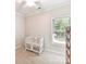 Cozy bedroom with a crib, window, and wicker dresser at 3801 Creek Ridge Dr, Denver, NC 28037