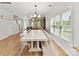 Bright dining area featuring a long table, bench seating, and large windows at 3801 Creek Ridge Dr, Denver, NC 28037