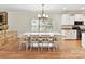 Sunlit dining area with a large table, white chairs, and built-in cabinets at 3801 Creek Ridge Dr, Denver, NC 28037