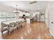 Open-concept kitchen with white cabinets, stainless steel appliances, and a large eat-in table at 3801 Creek Ridge Dr, Denver, NC 28037
