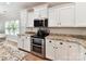 Bright kitchen featuring granite countertops, stainless steel appliances, and white cabinets at 3801 Creek Ridge Dr, Denver, NC 28037