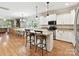 Open kitchen with white cabinetry, granite countertops, an island, and dining area at 3801 Creek Ridge Dr, Denver, NC 28037