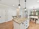 Bright eat-in kitchen with a granite island, white cabinets, and modern pendant lighting at 3801 Creek Ridge Dr, Denver, NC 28037