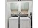 Functional laundry room with washer, dryer, storage cabinets, and shelving at 3801 Creek Ridge Dr, Denver, NC 28037