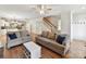 Spacious living room with hardwood floors that flows into the open kitchen and dining area at 3801 Creek Ridge Dr, Denver, NC 28037