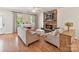 Bright living room featuring a stone fireplace, neutral furniture, and hardwood floors at 3801 Creek Ridge Dr, Denver, NC 28037