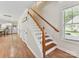 Staircase with wood treads, white risers, and a stained handrail, leading upstairs at 3801 Creek Ridge Dr, Denver, NC 28037