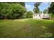 Expansive backyard with mature trees and lush lawn offers plenty of space for outdoor activities at 3920 Admiral Ave, Charlotte, NC 28205