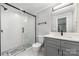 This bathroom is equipped with a glass shower, white subway tiles, and stylish fixtures at 3920 Admiral Ave, Charlotte, NC 28205