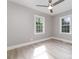 This bright bedroom is complete with vinyl floors, two windows, and a modern ceiling fan at 3920 Admiral Ave, Charlotte, NC 28205