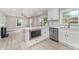 Modern kitchen with stainless appliances, white cabinets, island, and view into the adjacent living room at 3920 Admiral Ave, Charlotte, NC 28205