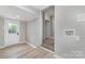 The well-lit laundry area has an exterior door, utility sink hookups, and updated flooring at 3920 Admiral Ave, Charlotte, NC 28205