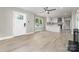 Bright, open-concept living room features modern flooring and leads to a kitchen with white cabinets at 3920 Admiral Ave, Charlotte, NC 28205