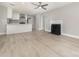Open-concept living room boasts a decorative fireplace and modern flooring adjacent to the eat-in kitchen at 3920 Admiral Ave, Charlotte, NC 28205