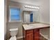 Bathroom featuring a sink with cabinet, a large mirror, and a window at 4006 Lawrence Daniel Dr, Matthews, NC 28104
