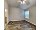 Bright bedroom with vaulted ceiling, window, and wood-look flooring at 4006 Lawrence Daniel Dr, Matthews, NC 28104